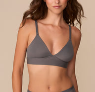 Alexis wearing the Bliss Triangle Bralette in Smoke. The front view shows the deep V-neckline, adjustable straps, and smooth underband for wire-free support. sizing: Alexis wears size Small