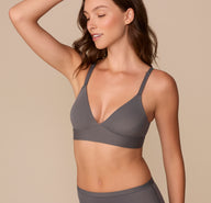 Side view of Alexis in the Bliss Triangle Bralette in Smoke, showcasing the soft fabric, gentle shaping, and lightweight design.