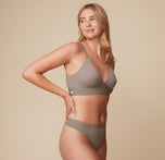 Megan turns slightly to the side, wearing the Bliss Triangle Bralette in Desert. The clean lines and comfortable band create a smooth silhouette.