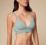 Close-up of Anna wearing the Bliss Triangle Bralette in Seaglass. The fine details of the soft, stretchy fabric, supportive construction, and low cut v-neck are visible.