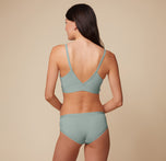 Anna is shown from the back in the Bliss Triangle Bralette in Seaglass. The adjustable straps and low cut v back highlight its functional design.