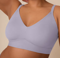 A close-up of Zarria wearing the Bliss Triangle Bralette in Violet, showing detailed features like the molded cups, smooth V-neckline, and supportive underband for a seamless, wire-free silhouette.