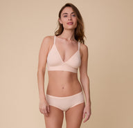 Gracie wears the Bliss Triangle Bralette in Rose with the matching Bliss Hiphugger. The set emphasizes a smooth, second-skin fit.