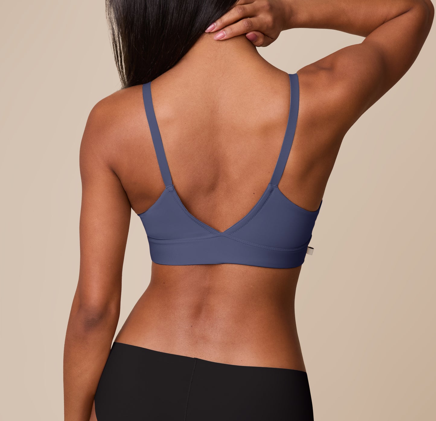 Back view of Ally in the Bliss Triangle Bralette in Twilight. The wide V-shaped back and smooth straps provide light support and an elegant silhouette.
