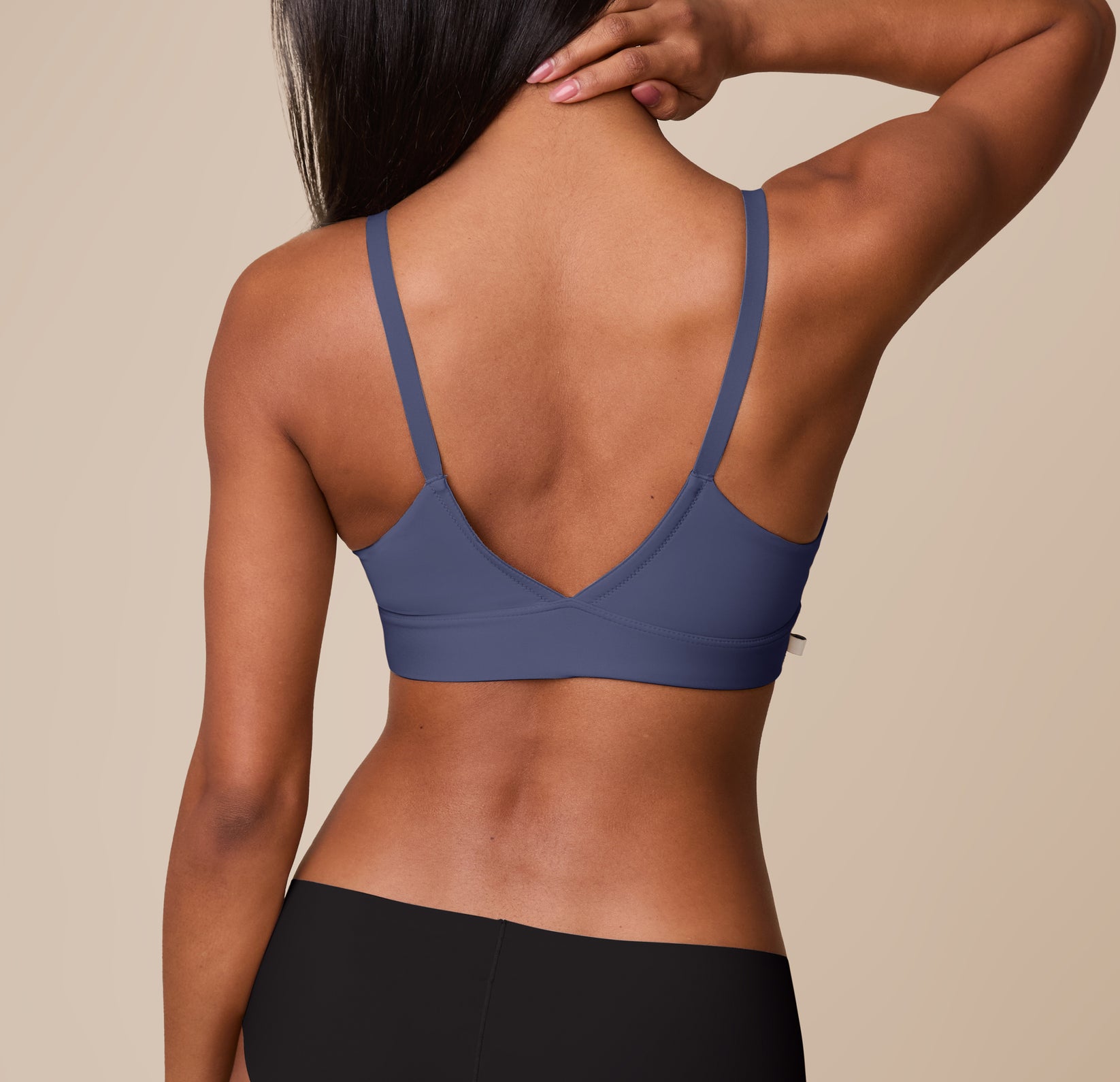 Back view of Ally in the Bliss Triangle Bralette in Twilight. The wide V-shaped back and smooth straps provide light support and an elegant silhouette.