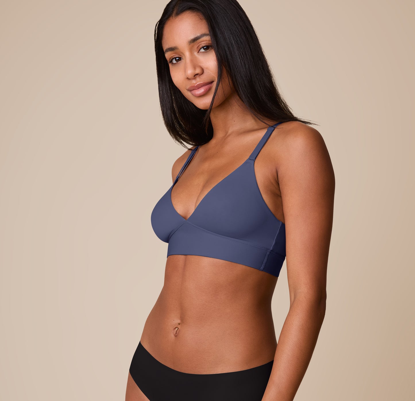 Ally stands at a slight angle wearing the Bliss Triangle Bralette in Twilight, highlighting the bralette’s plunging neckline, lightly lined cups, and soft sculpting.