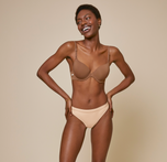Woman wearing the bliss thong in color beige