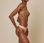 Woman wearing the bliss thong in color beige