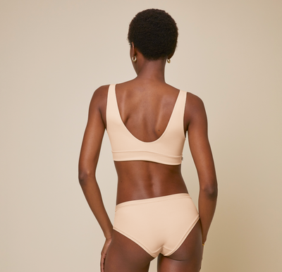 Woman wearing the Bliss Bralette in the color Beige