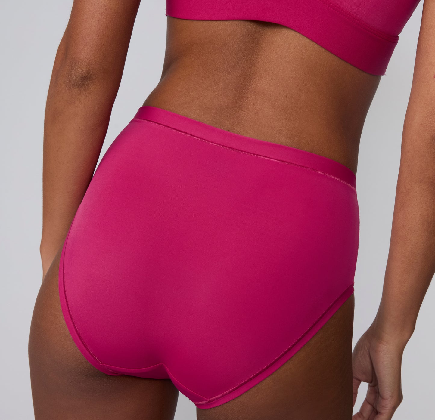 Back view on a white studio backdrop of the Bliss High Waist in Winterberry, highlighting the smooth, full-coverage back and clean leg openings.