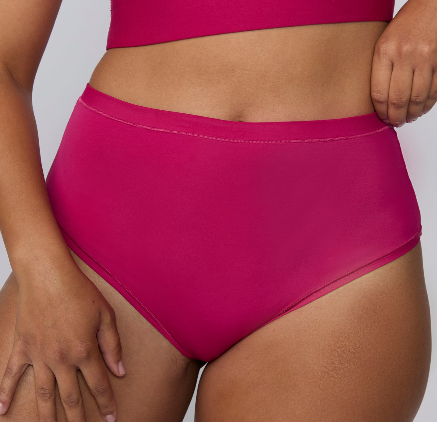 Close-up front view on a white studio backdrop of the Bliss High Waist in Winterberry, focusing on the soft waistband and smooth microfiber texture.