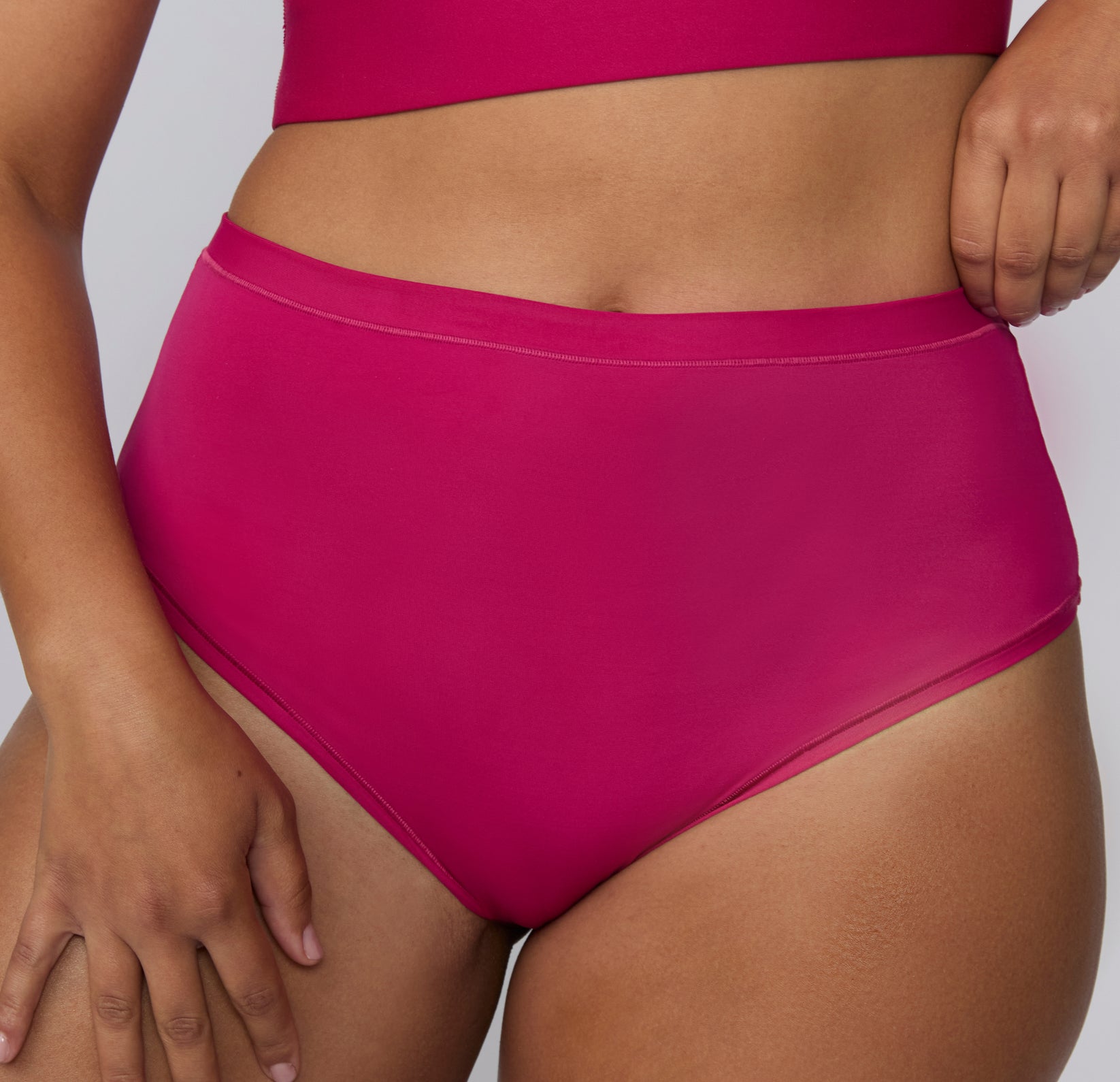 Close-up front view on a white studio backdrop of the Bliss High Waist in Winterberry, focusing on the soft waistband and smooth microfiber texture.