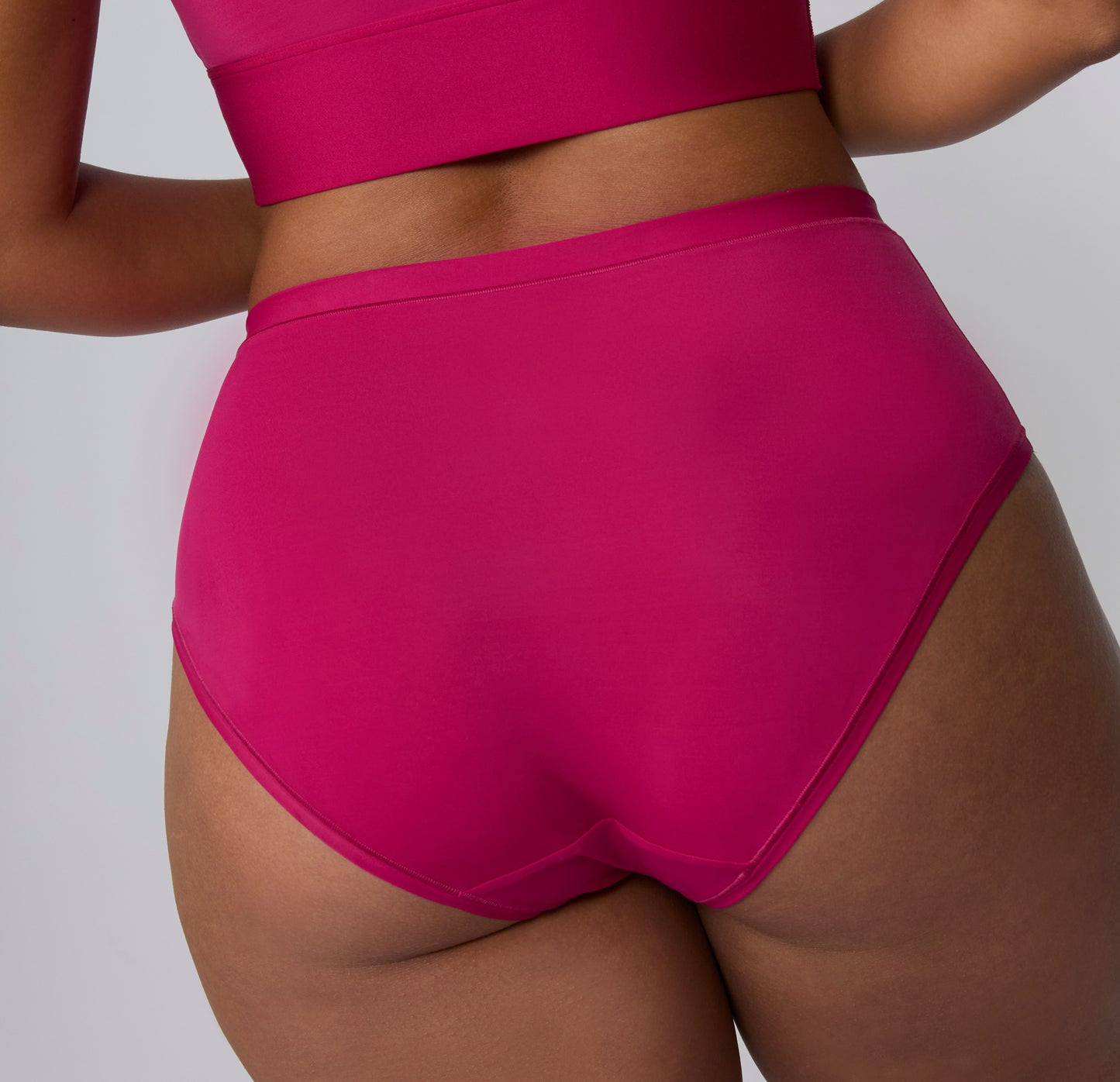 Angled back view on a white studio backdrop of the Bliss High Waist in Winterberry, showing the high-rise fit, full back coverage, and smooth edges.