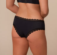 Back view of Sonnie in the Bliss Lace Cheeky Brief in Black. The image showcases the cheeky rear cut with soft lace edges designed to lay flat without digging.