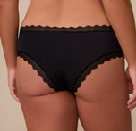 Close-up back angle of Sonnie wearing the Bliss Lace Cheeky Brief in Black. The image highlights the minimal coverage and stretch lace trim designed for a barely-there feel.