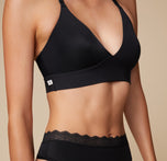 Close-up side view of Anna wearing the Bliss Lace Halterneck Bralette in Black. The image focuses on the bralette’s smooth fit and lace details.