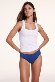 Model Linni wearing the Harper Wilde Bliss Tank in White — square neckline and wide straps in buttery soft Bliss fabric.