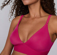 Close-up on a white studio backdrop of the Bliss Triangle Bralette in Winterberry, highlighting the deep V-neckline, smooth microfiber fabric, and adjustable straps.