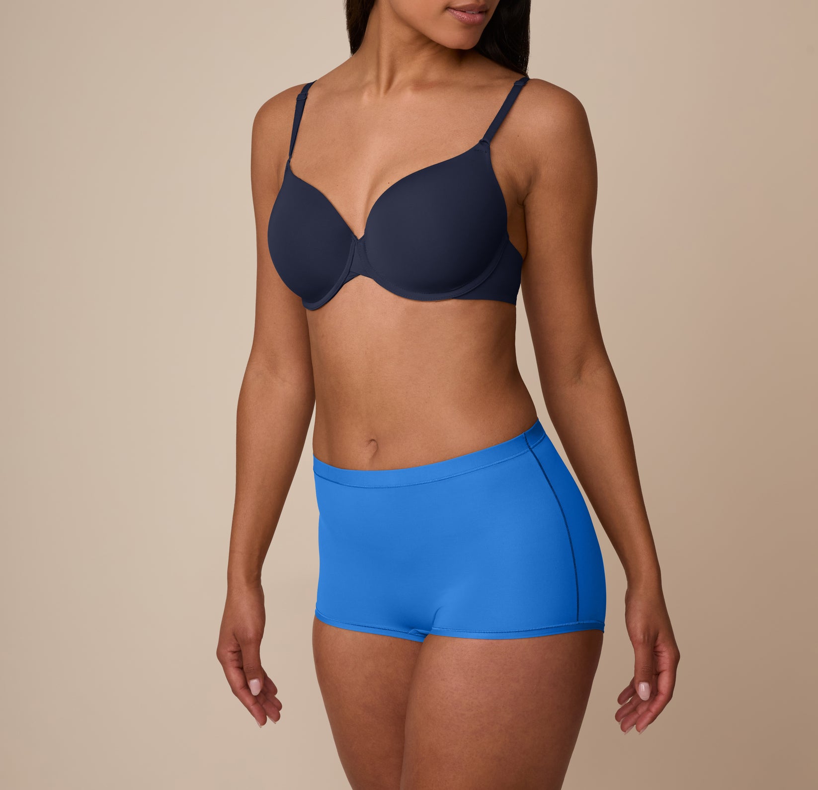 Nemesis wears the Bliss Boyshort in Bluebird in a ¾ side view, highlighting the elastic-free leg openings and soft, smoothing fabric.