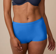 A close-up of Nemesis wearing the Bliss Boyshort in Bluebird, focusing on the soft microfiber fabric and elastic-free waistband.