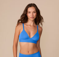 Front view of Alexis wearing the Bliss Triangle Bralette in Bluebird, showing the V-neck cups and smooth, lightweight microfiber design.