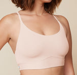 A close-up side view of the Bliss Racerback Bralette in Rose, worn by Carli. The image focuses on the bralette's soft fabric and its comfortable fit.