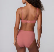 On a light gray studio backdrop, Courtney wears the Bliss Highwaist in Cinnamon, shown from the back. The high-waisted underwear features smooth, full back coverage and soft microfiber fabric designed for comfortable, everyday wear with a no-show feel under clothing.