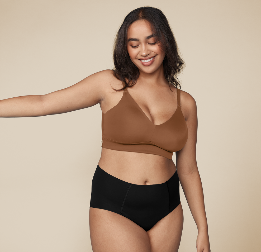 Woman wearing the Bliss Triangle Bralette in the color Brown sizing: Claudia wears size Large. Sizes L-6XL have higher center in front for additional support.