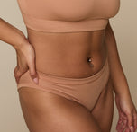 Detail close-up of the Cloud Cotton Bikini in Dune on Jade, focusing on the waistband and hip area to show the soft structure and elastic-free edges.