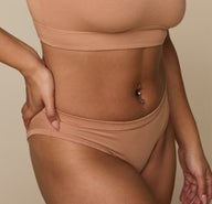Detail close-up of the Cloud Cotton Bikini in Dune on Jade, focusing on the waistband and hip area to show the soft structure and elastic-free edges.