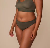 Side view of Zarria wearing the Cloud Cotton Bikini in Olive, showing the mid-rise fit and soft cotton-modal fabric.