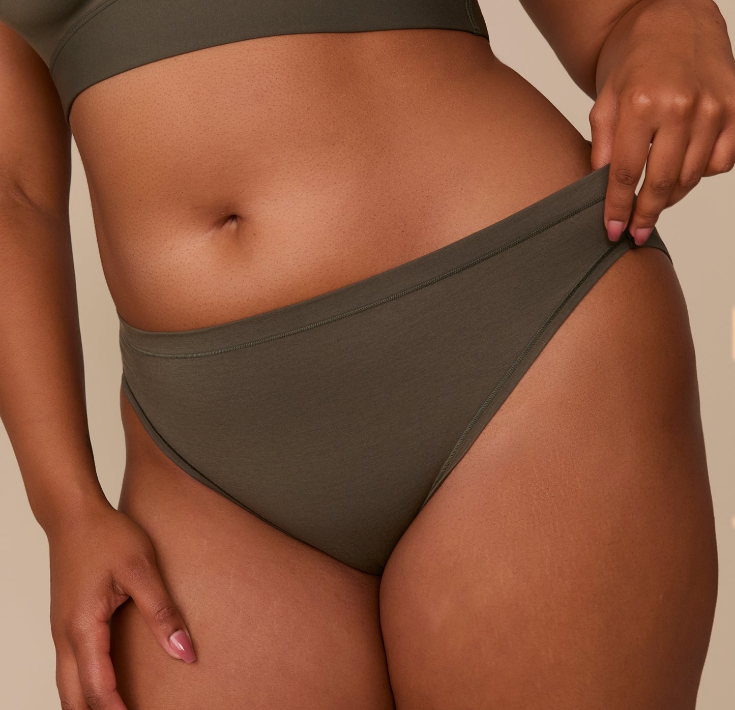 Close-up of Zarria wearing the Cloud Cotton Bikini in Olive, focusing on the soft waistband and breathable cotton-modal blend.