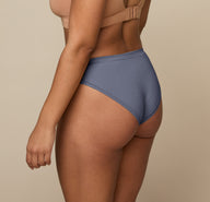 Back angle of Jade in the Cloud Cotton Bikini in Slate, showing the smooth fabric and moderate back coverage.