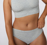 Close-up front view on a light studio backdrop of the Cloud Cotton Bikini in Light Heather Grey, focusing on the soft waistband and smooth fabric texture.