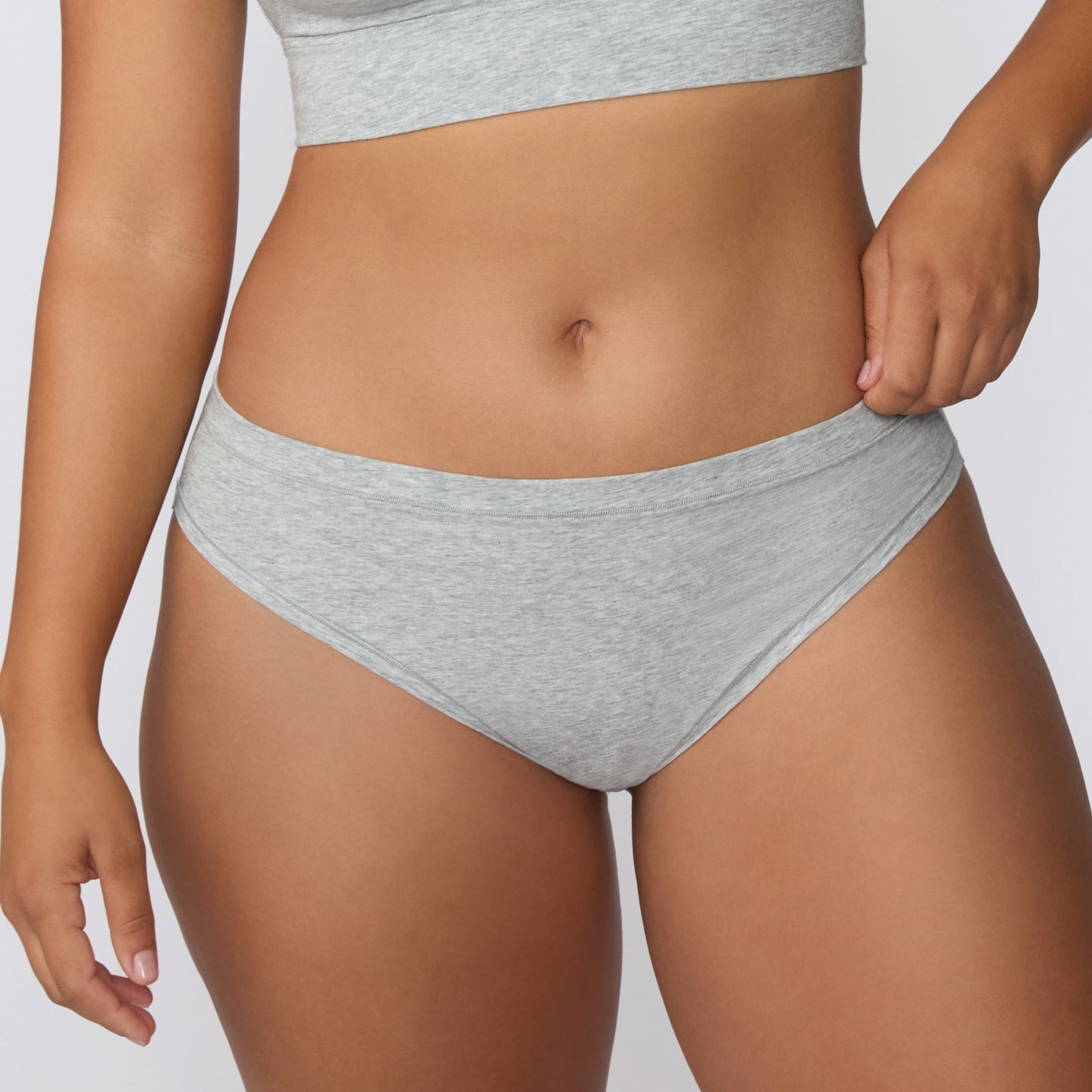 Close-up front view on a light studio backdrop of the Cloud Cotton Bikini in Light Heather Grey, focusing on the smooth waistband and soft fabric texture.