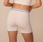 Rear view of Freya in the Cloud Cotton Retro Boxer Brief in Quartz. The wide waistband and comfortable, mid-thigh length offer full coverage and a secure fit.