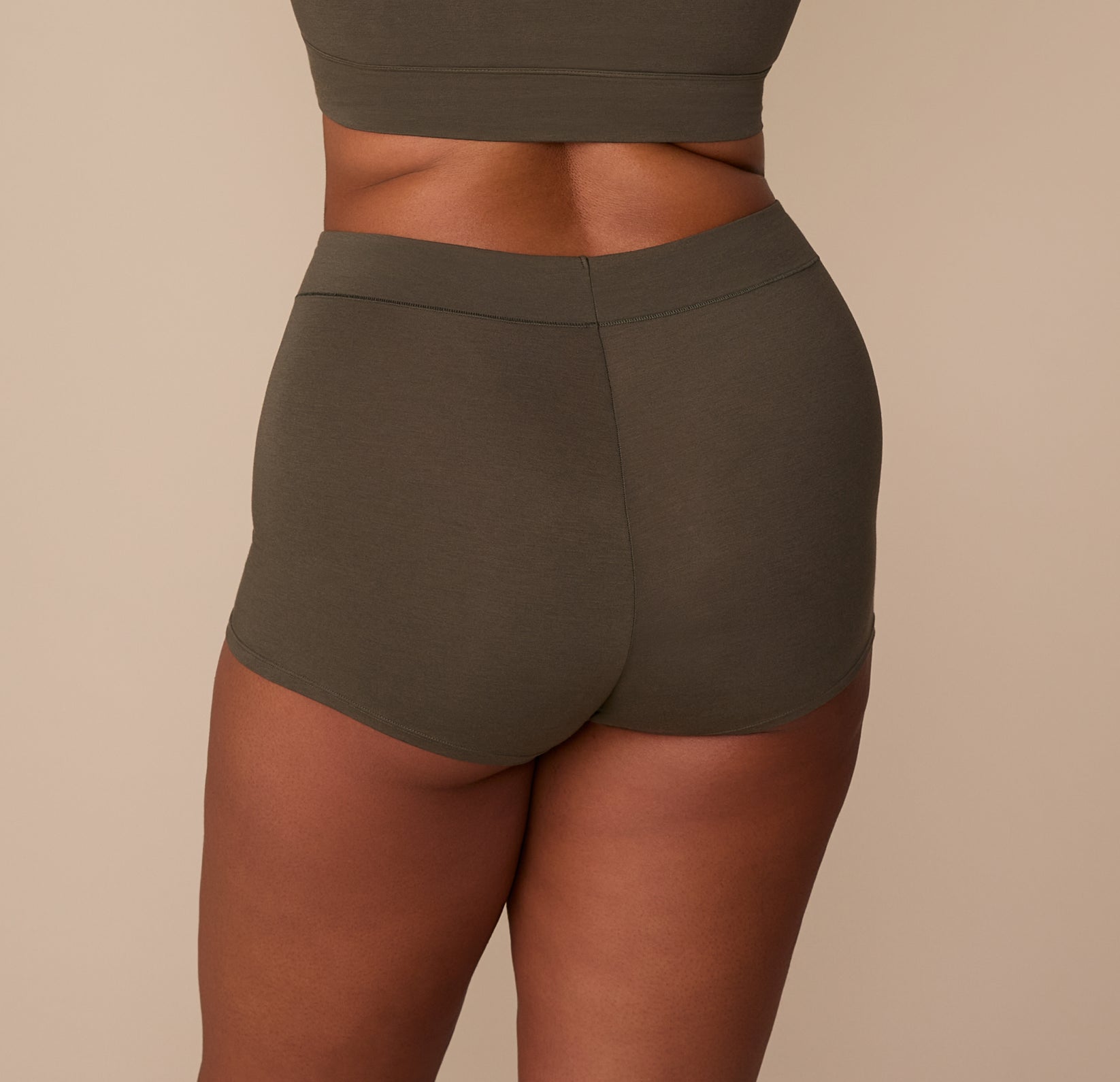 Back view of Zarria in the Cloud Cotton Highwaist Boyshort in Olive, highlighting the smooth, full-coverage back.
