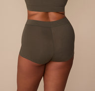 Back view of Zarria in the Cloud Cotton Highwaist Boyshort in Olive, highlighting the smooth, full-coverage back.