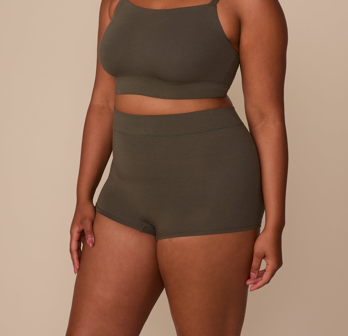 Side view of Zarria wearing the Cloud Cotton Highwaist Boyshort in Olive, showing the high-rise waistband and hip coverage.