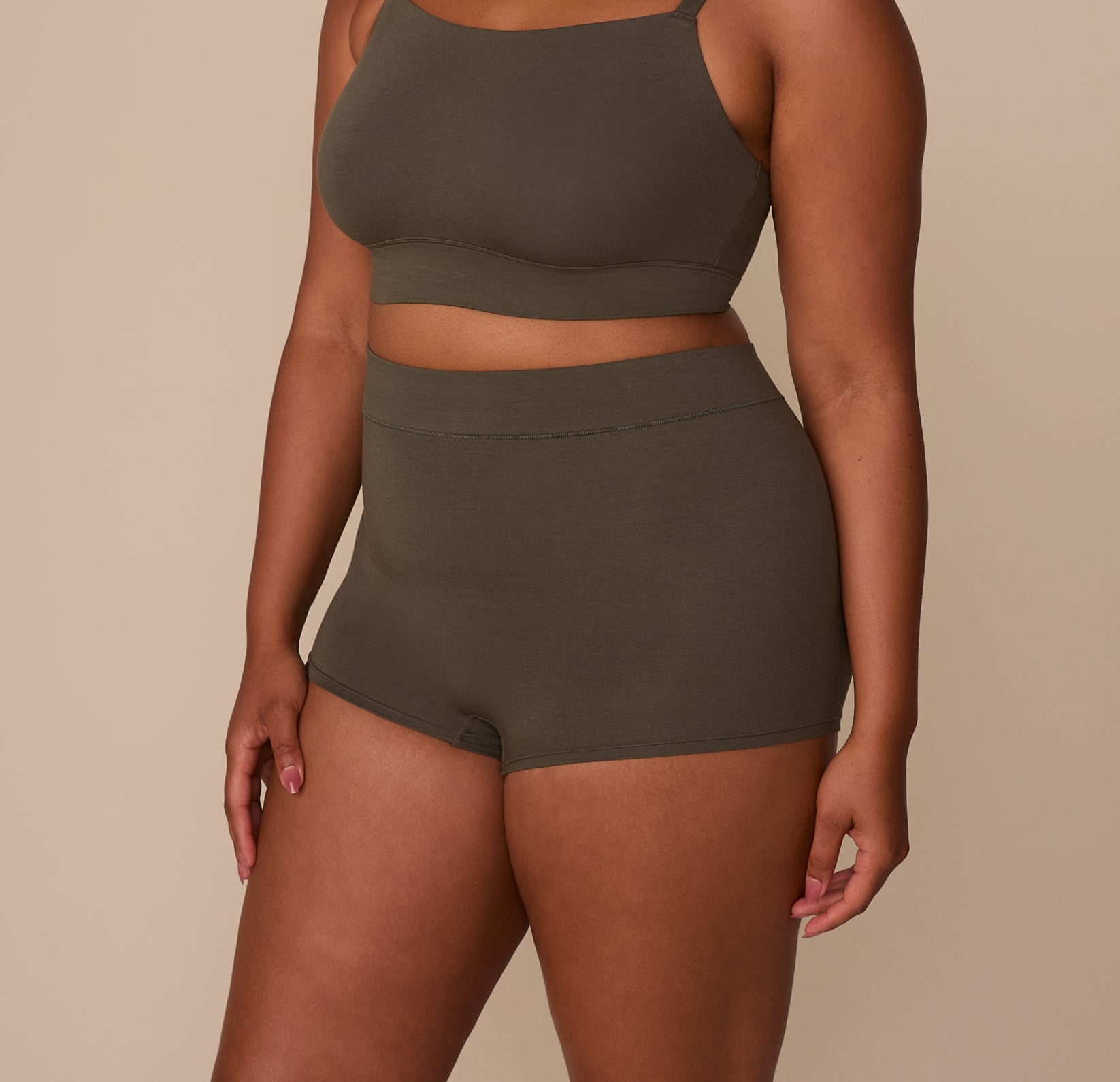 Side view of Zarria wearing the Cloud Cotton Highwaist Boyshort in Olive, showing the high-rise waistband and hip coverage.