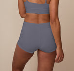 Back view of model wearing the Cloud Cotton Highwaist Boyshort in Slate. The high waistband, minimal seams, and ultra soft cotton fabric are emphasized.