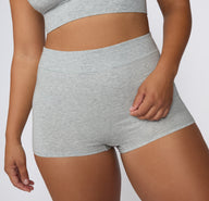 On a white studio backdrop, the Cloud Cotton Boyshort in Heather Grey is shown from the front, featuring a high-rise waist and full-coverage boyshort silhouette in soft cotton modal fabric.