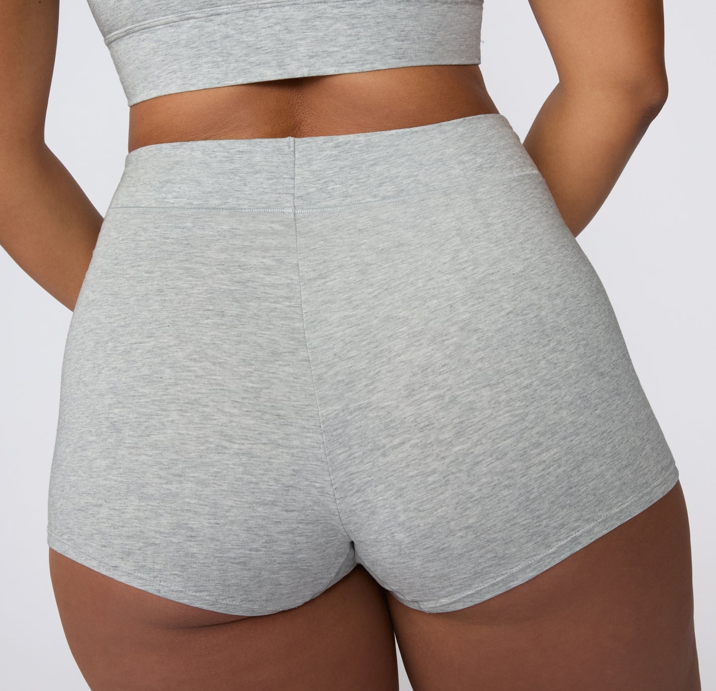 On a white studio backdrop, the Cloud Cotton Boyshort in Heather Grey is shown from the back, highlighting full back coverage and a smooth, elastic waistband.