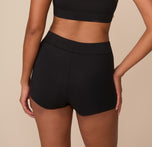 Rear view of Victoria in the Cloud Cotton Highwaist Boyshort in Black. The image showcases the smooth, minimal seam look and longer leg length for added coverage and comfort.