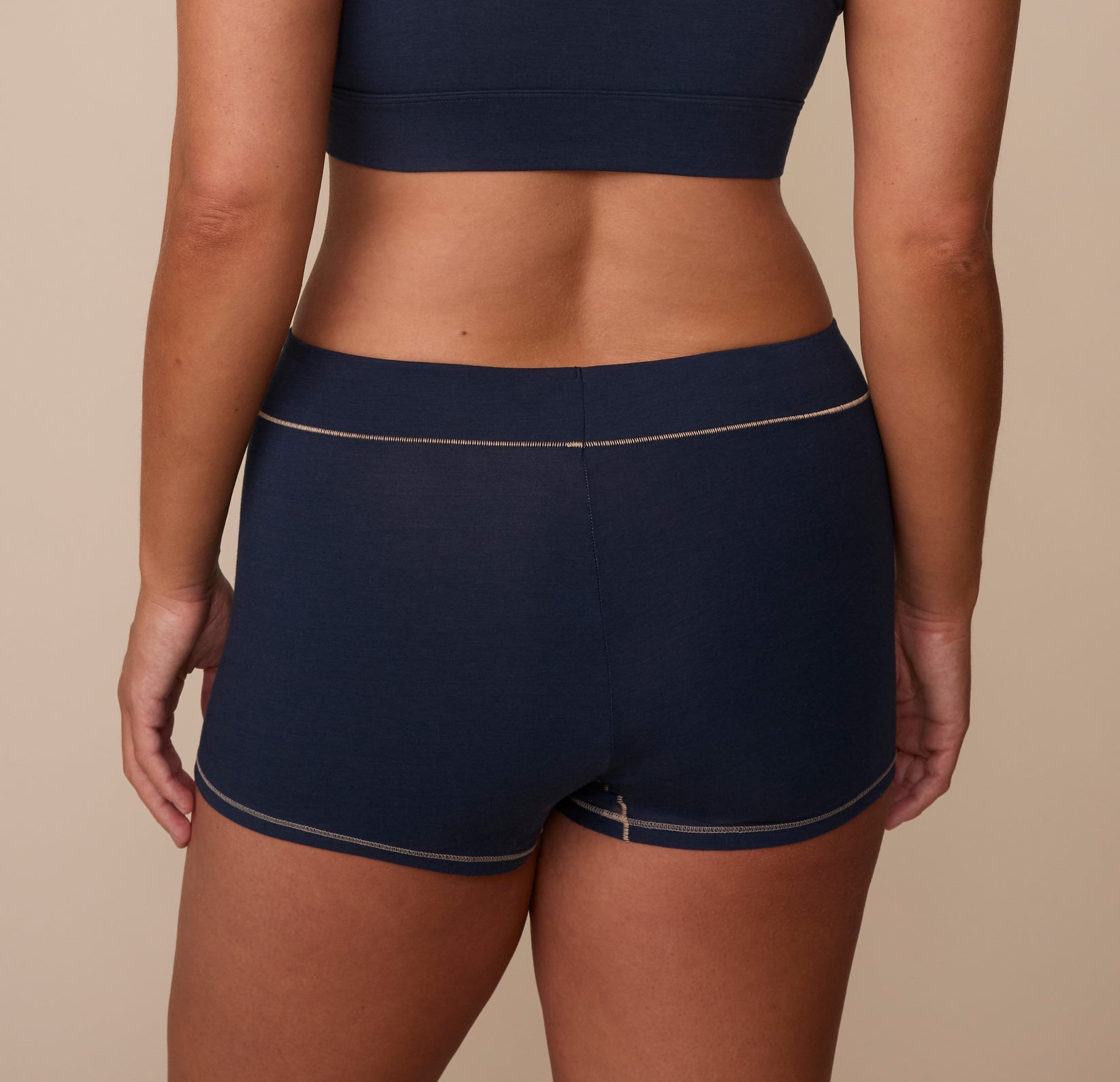 Rear view of Sonnie in the Cloud Cotton Highwaist Boyshort in Midnight. The photo showcases the wide waistband and mid-to-full back coverage for all-day comfort.