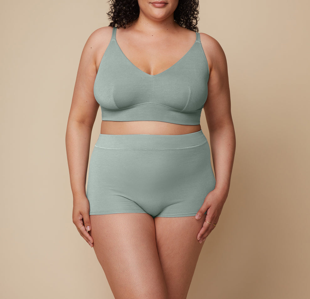 Bianca stands facing forward, highlighting the smooth waistband and the supportive yet lightweight fabric of the Cloud Cotton Highwaist Boyshort in Seaglass. sizing: Bianca wears XL