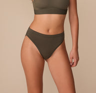 Alexis wearing the Cloud Cotton French Cut Brief in Olive, front view showing high-cut leg opening and mid-rise waist. sizing: Alexis wears size Small