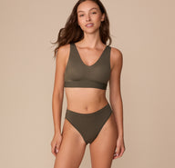 Full-body view of Alexis in the Cloud Cotton French Cut Brief in Olive, styled with the matching Bliss Bralette in Olive.