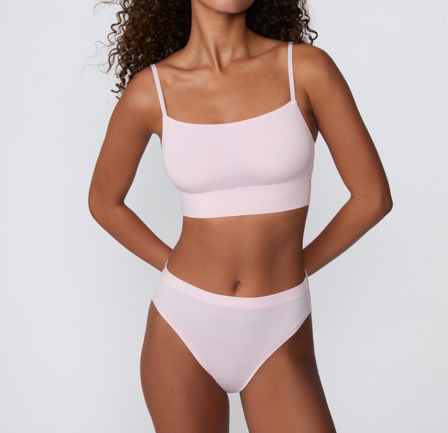 On a clean studio backdrop, a mid-body front view shows a model wearing the Cloud Cotton French Cut Brief in Primrose, featuring the French-cut leg opening and soft cotton modal fabric.