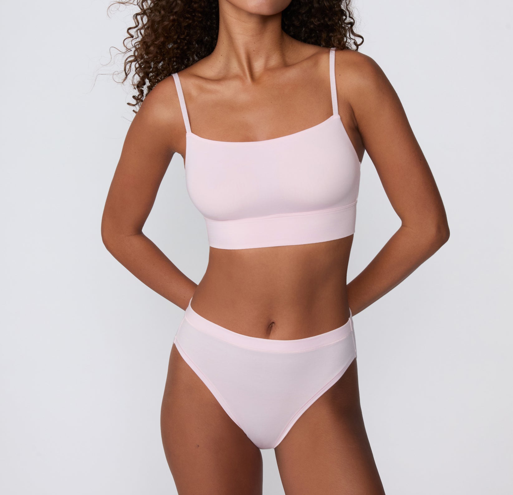 On a clean studio backdrop, a mid-body front view shows a model wearing the Cloud Cotton French Cut Brief in Primrose, featuring the French-cut leg opening and soft cotton modal fabric.